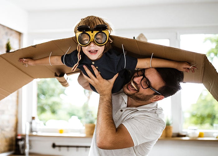 Father holding son up like an airplane